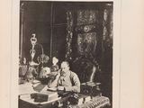 an old black and white photo of a man sitting at a desk