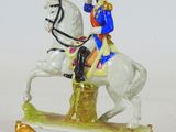 a figurine of a man riding a horse