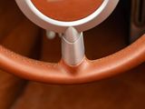 a close up of a steering wheel with a clock on it