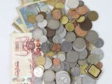 a pile of coins and money on a white surface