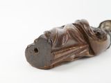 a statue of a man laying down on a white surface