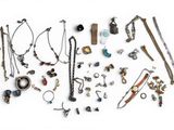 many different types of necklaces and bracelets laid out on a white surface