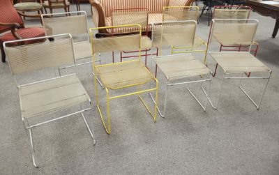 several chairs and a table in a room with chairs and a couch