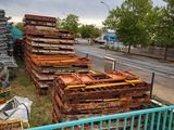 a lot of pallets that are sitting on the side of the road
