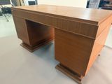 a wooden desk with two drawers on it in a room