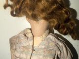 a close up of a doll with a hat on it