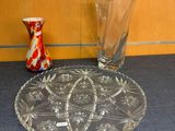 two vases and a glass plate on the table