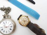 a watch, a watch chain, and a watch on a table