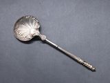 a close up of a spoon on a table with a black background