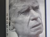 an open book with a black and white photo of a man ' s face