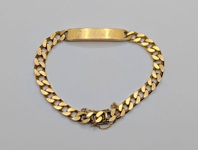 a gold bracelet with a curb link