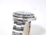 a close up of a watch on a white surface