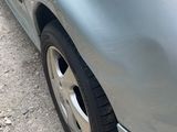 a close up of a car ' s front bumper and tire