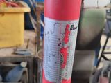 a red fire extinguisor sitting in a garage