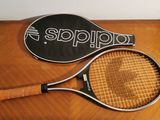two tennis rackets sitting on a table next to each other
