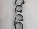 four pairs of black clamps on a white surface