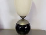 an image of a black and white glass lamp on a table