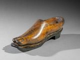an old wooden shoe is sitting on top of a table