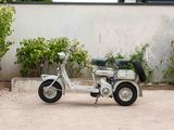 a small motor scooter parked in a parking lot