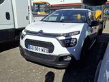 a white car that is parked next to a white truck