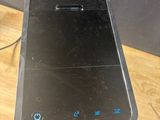 a cell phone sitting on top of a stand on a table