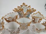 many cups and saucers sitting on a tray