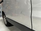 a white van parked in a garage with a blue sign on the side of the van