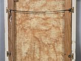 an old picture of a wooden frame with a string attached to it