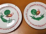 two plates that have been painted with flowers on them