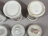 four cups and a saucer sitting on a table