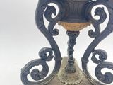 a vase that is on a stand on a white background