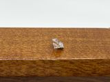 a small piece of silver sitting on top of a wooden box