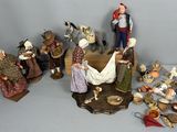 many figurines of people that are sitting on a table