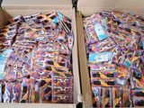 two boxes filled with different colored ties on top of a table