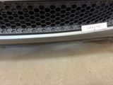 a close up of the front bumper of a car with a sticker on it