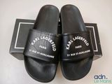 the pair of black slides are sitting on top of a box