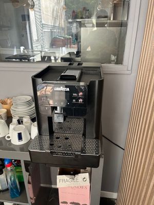 a coffee machine sitting on a shelf in a kitchen