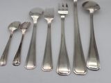 five forks and five spoons sitting on a table