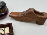 a wooden shoe with dice in it next to a clock