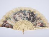 a fan with a painting on it sitting on a table