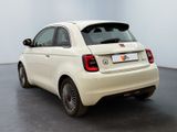 the small white car is parked in a room with a white wall
