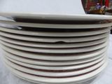 several white plates stacked on top of each other on a table