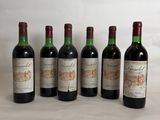 six bottles of wine are lined up in a row on a table