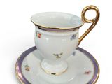 a cup and saucer on a saucer on a white surface