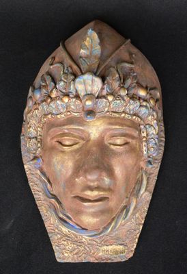sculpture of a man ' s face with a crown on his head