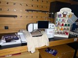a sewing machine sitting on top of a desk next to other sewing supplies