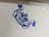 a blue and white plate with a bird on it