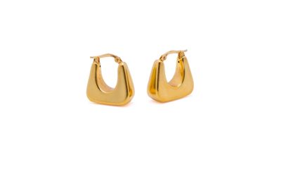 a pair of gold hoop earrings on a white background