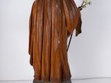 statue of a person with a flower in their hand and a bird on top of it
