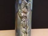 a vase that has a flower on it on a table